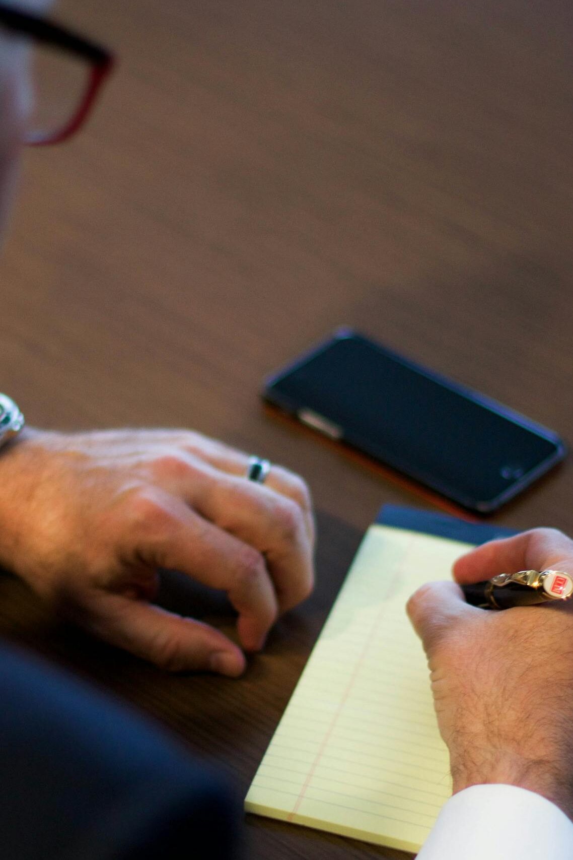 Person Writing Notes on White Ruled Paper